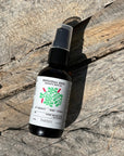Bunya Patchouli Zest aromatherapy bottle on a wooden surface