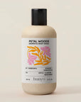 Bottle of Petal Woods Aromatic Body Wash by banyo on a beige background