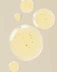 Close-up of transparent liquid droplets on a beige background