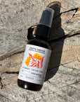 Bottle of Exotic Castor aromatic hair treatment on a wooden surface
