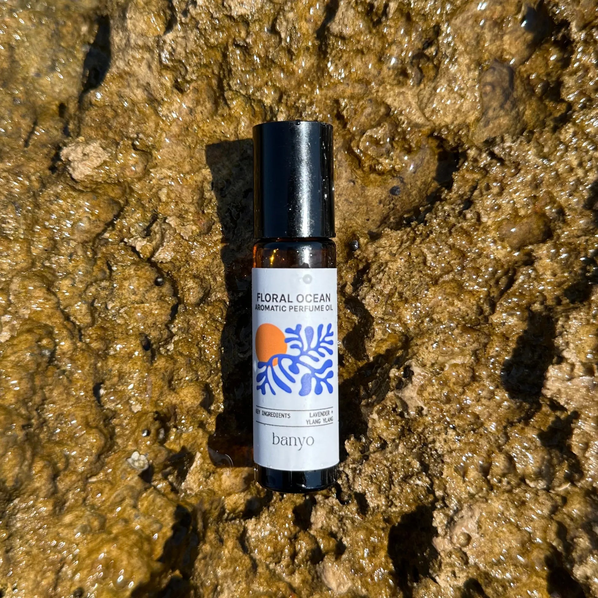 Bottle of 'Floral Ocean' perfume by banyo on a textured brown surface