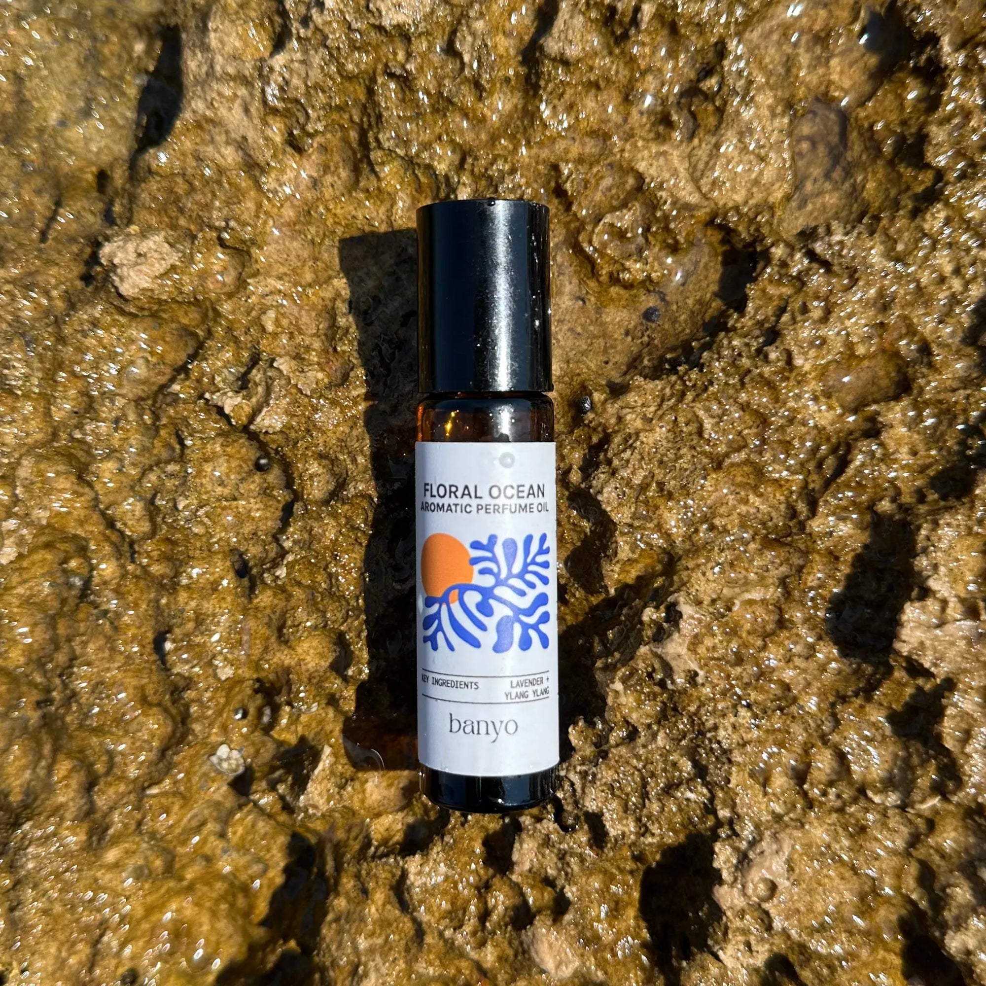 Bottle of 'Floral Ocean' perfume by banyo on a textured brown surface