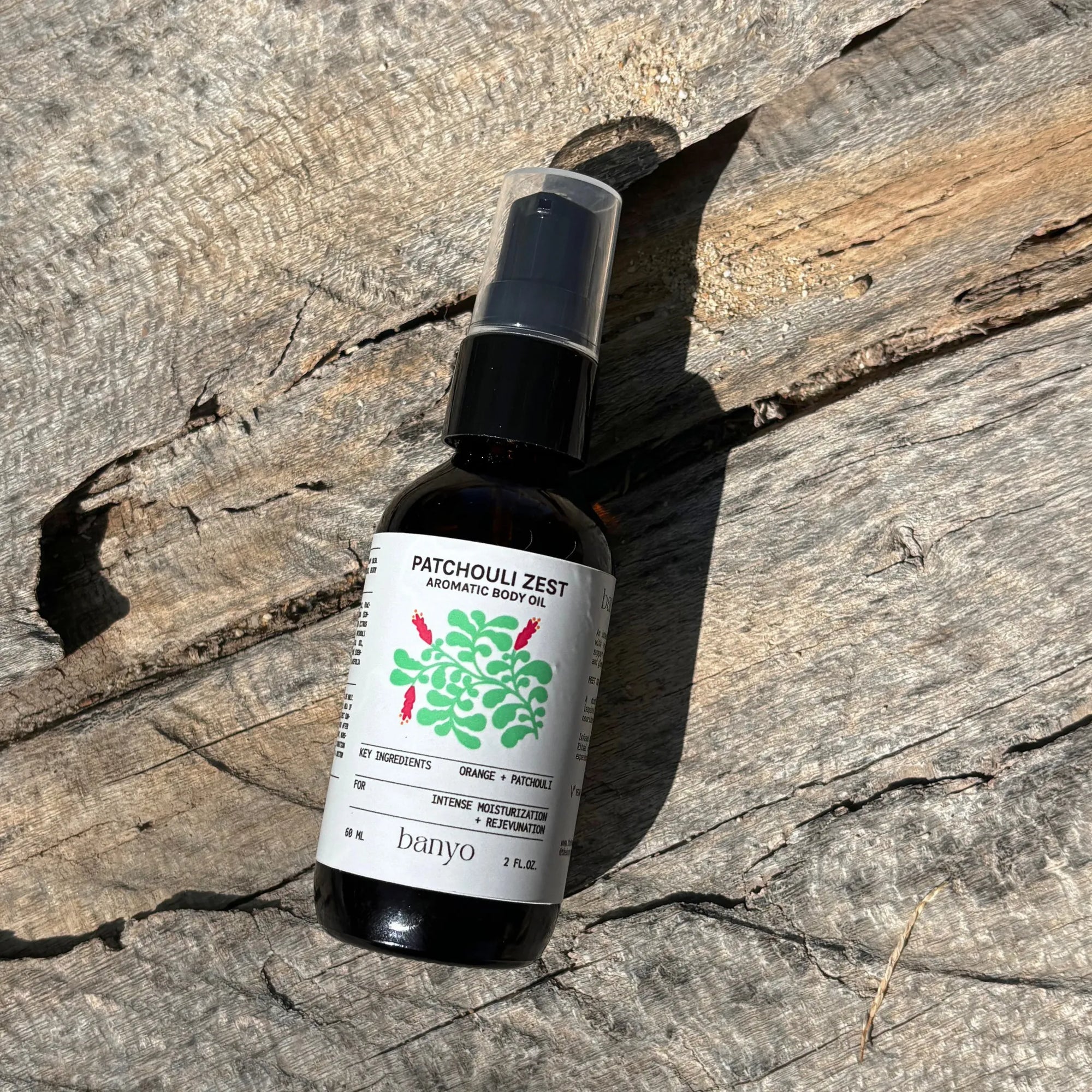 Banyo Patchouli Zest aromatherapy bottle on a wooden surface