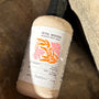 Bottle of banyo Petal Woods Aromatic Body Wash on a stone surface