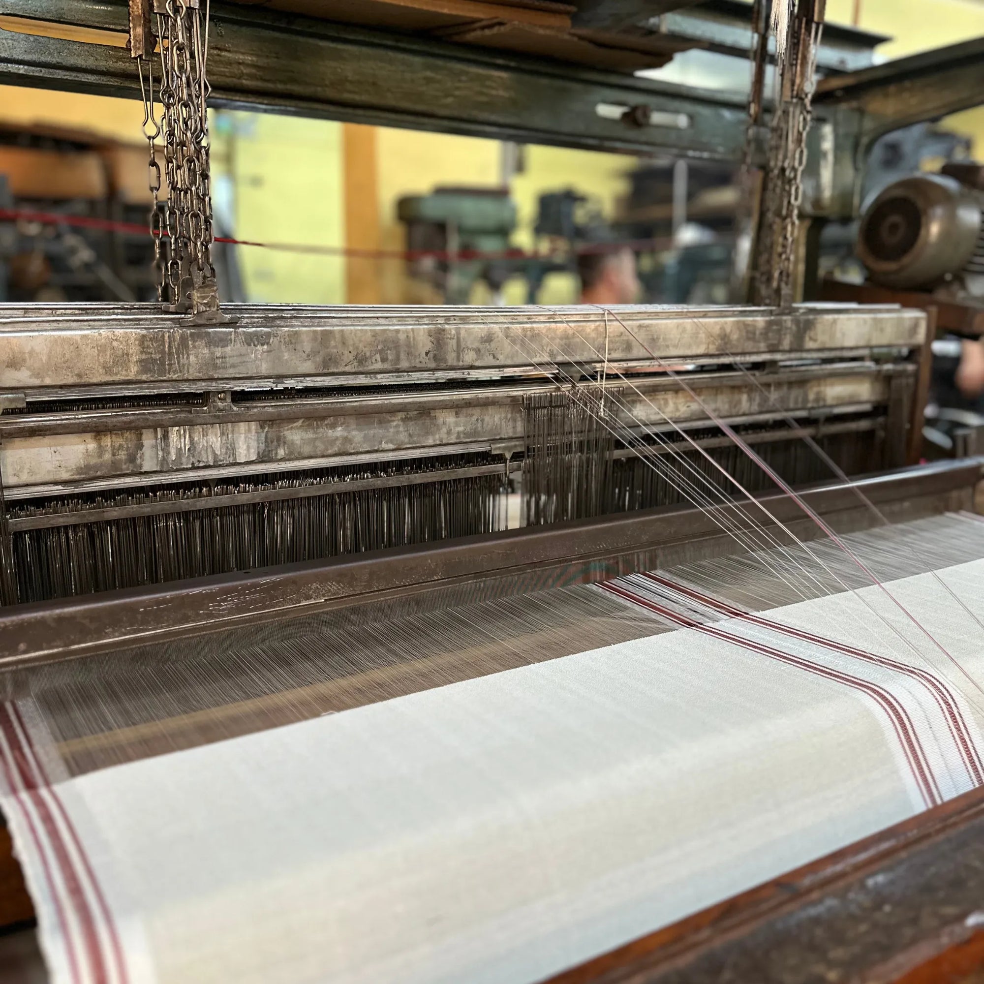 Weaving loom with fabric in a workshop setting