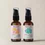 Two brown bottles of banyo aromatherapy body oils on a beige background