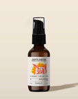 Brown bottle of Exotic Castor hair treatment with a label on a beige background