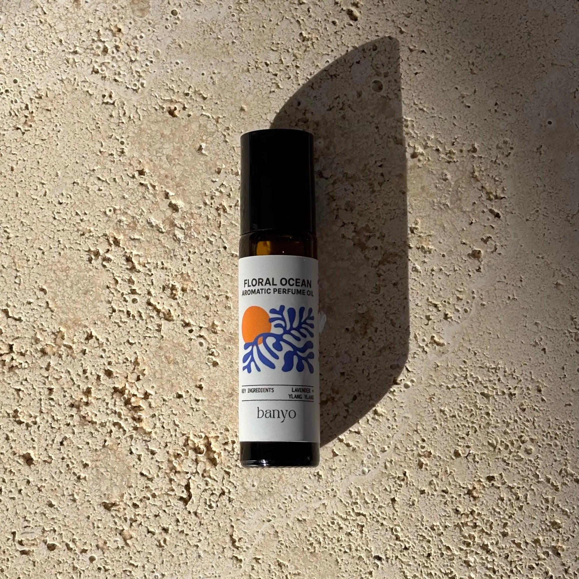 Bottle of 'Floral Ocean' perfume oil by banyo on a textured beige surface