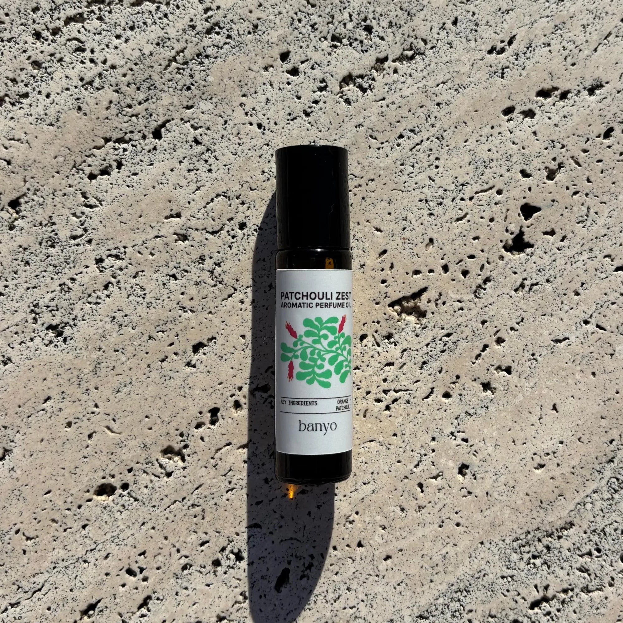 Perfume bottle with label on a textured stone surface