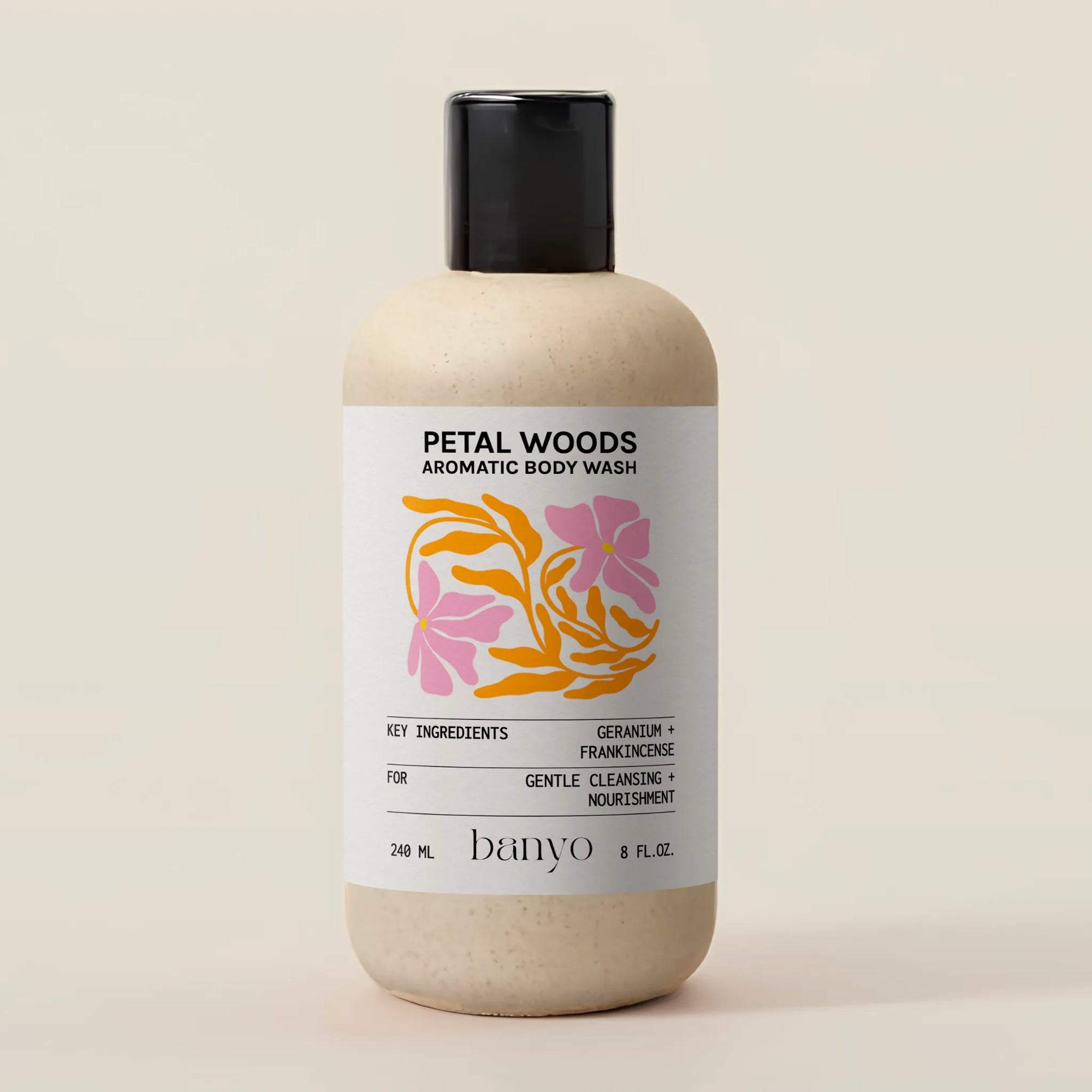 Bottle of Petal Woods Aromatic Body Wash by banyo on a beige background