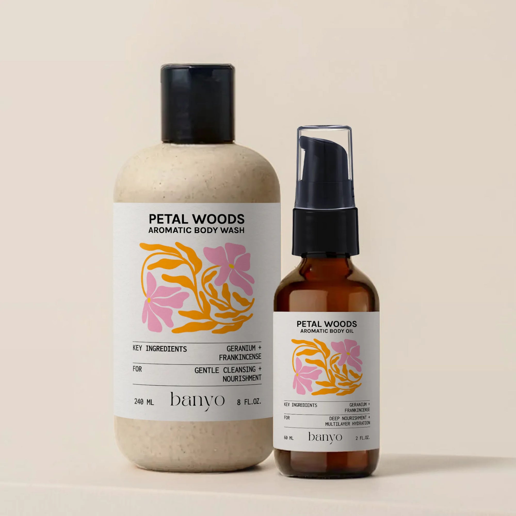 Two bottles of Petal Woods Aromatic Body Wash and Oil by banyo on a beige background