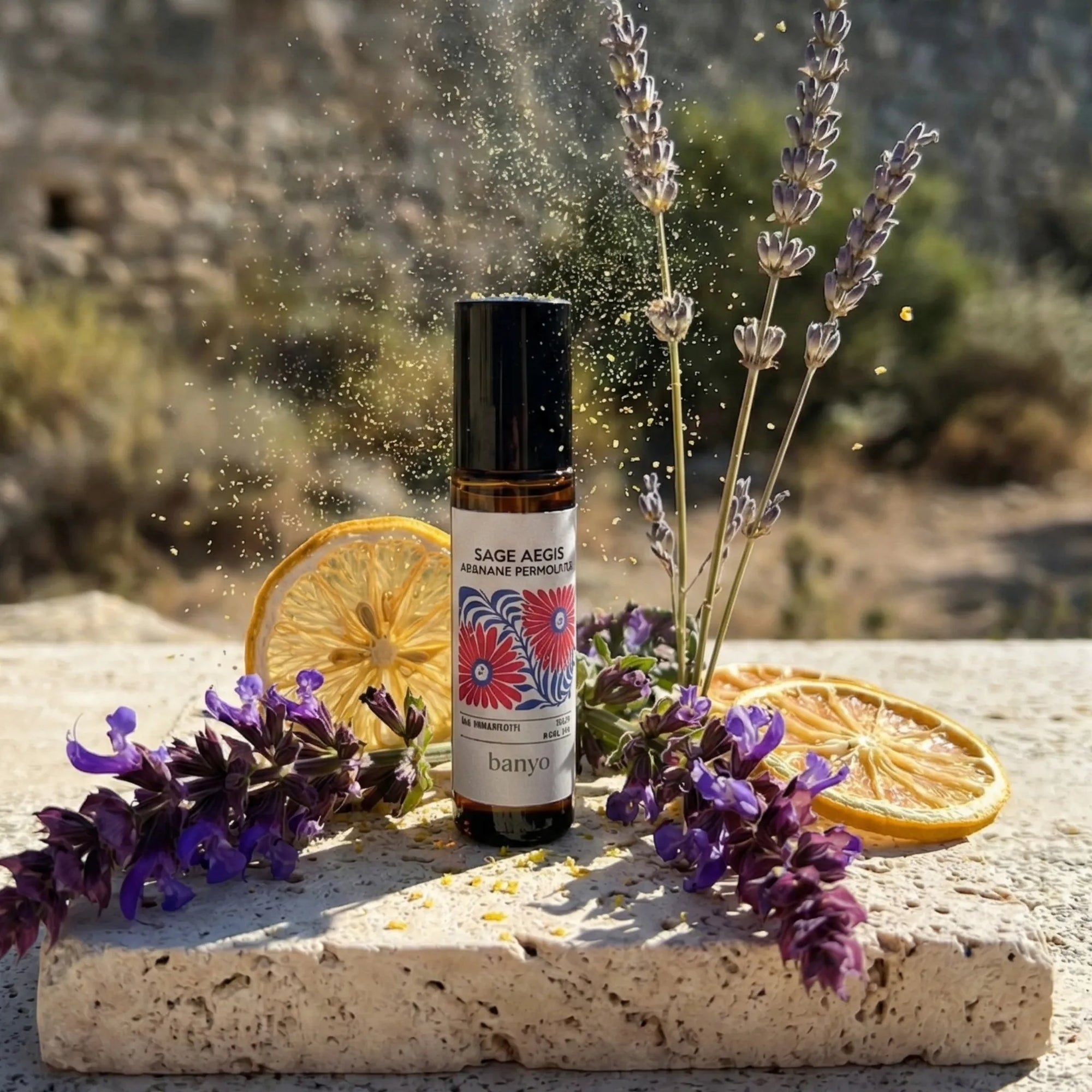 Bottle of Sage Aegis with dried lavender and lemon slices on a stone surface