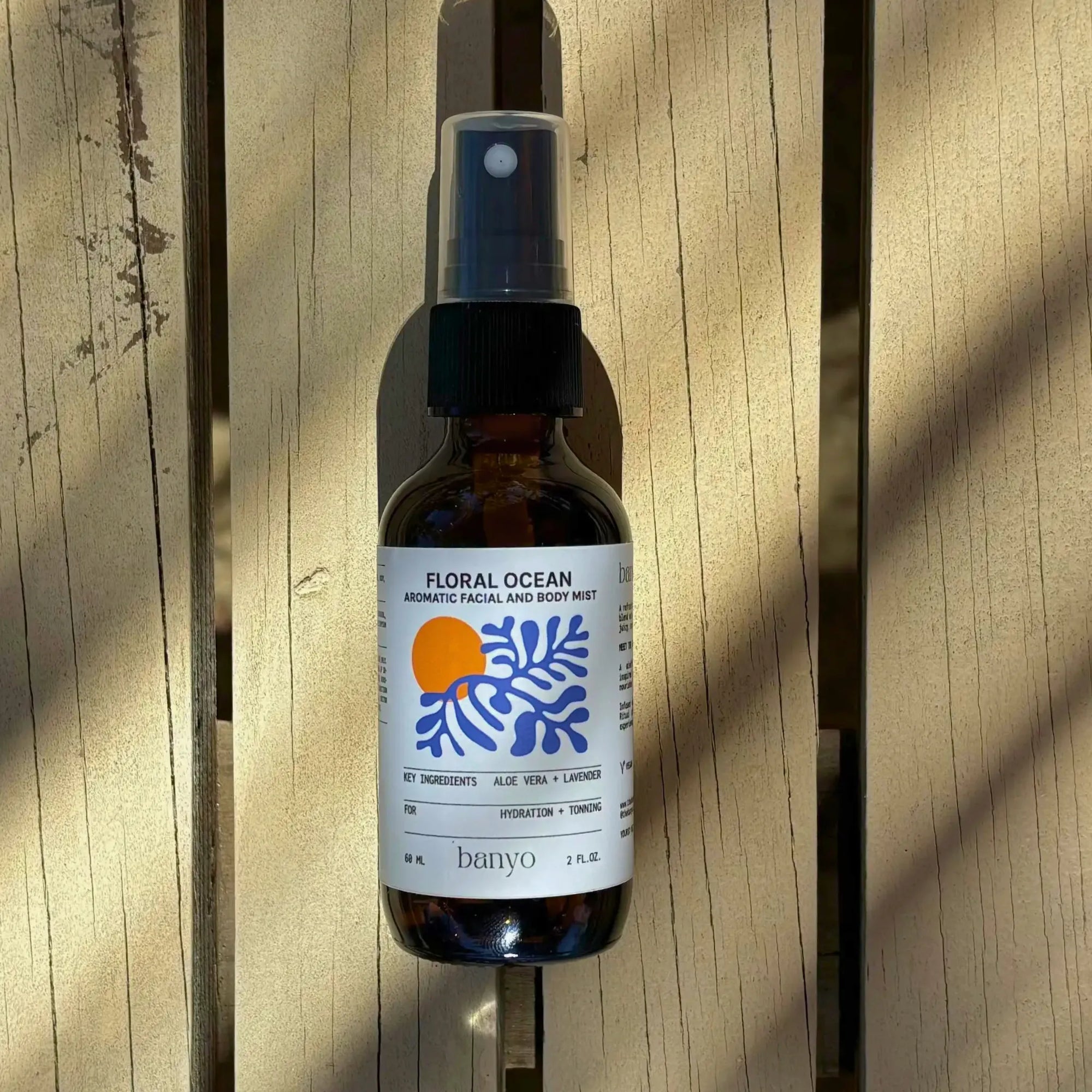Bottle of 'Floral Ocean' mist on a wooden surface